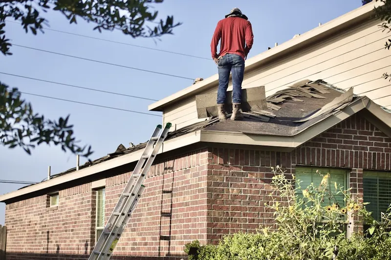 Professional roofer working on a residential roof in Bellmore